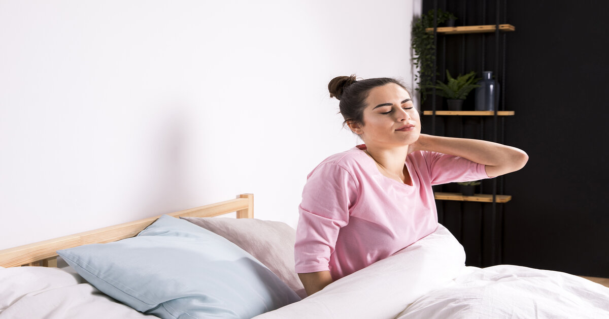 girl facing back pain from sleeping in a wrong way